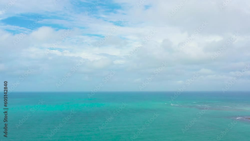 Turquoise surface of the sea against the sky and clouds, aerial view. Water cloud horizon background. Blue sea water with small waves against sky. Turquoise surface of the sea against the sky and clouds, aerial view. Water cloud horizon background. Blue sea water with small waves against sky.