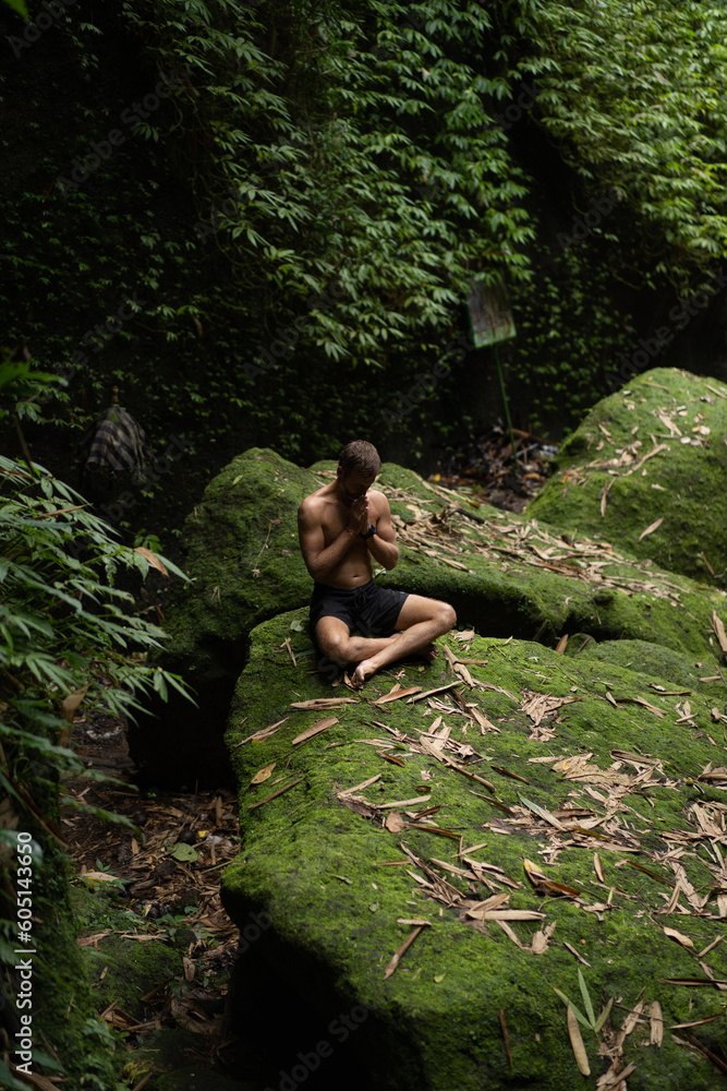 Man meditates in nature in the jungle. Breathing and balance. Man meditates in nature in the jungle. Breathing and balance.