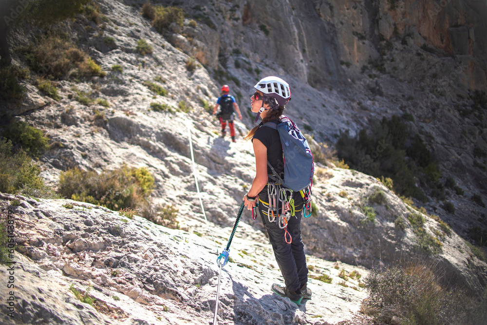 two climbing sports technicians check the condition of a via ferrata two climbing sports technicians check the condition of a via ferrata