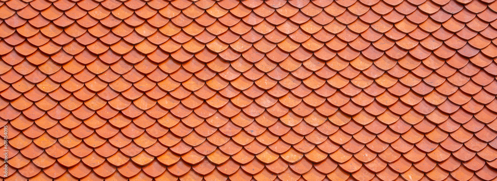 Tiles on the roofs of houses. Roof made of ceramic tiles close-up as a background. Roofing.