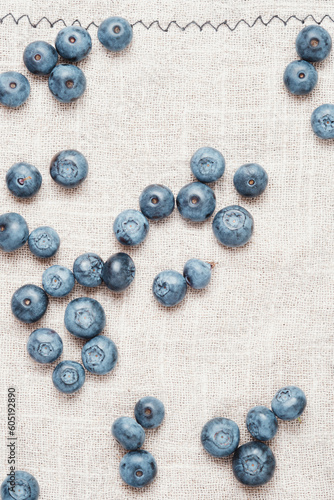 Fresh blueberries scattered on a linen napkin.