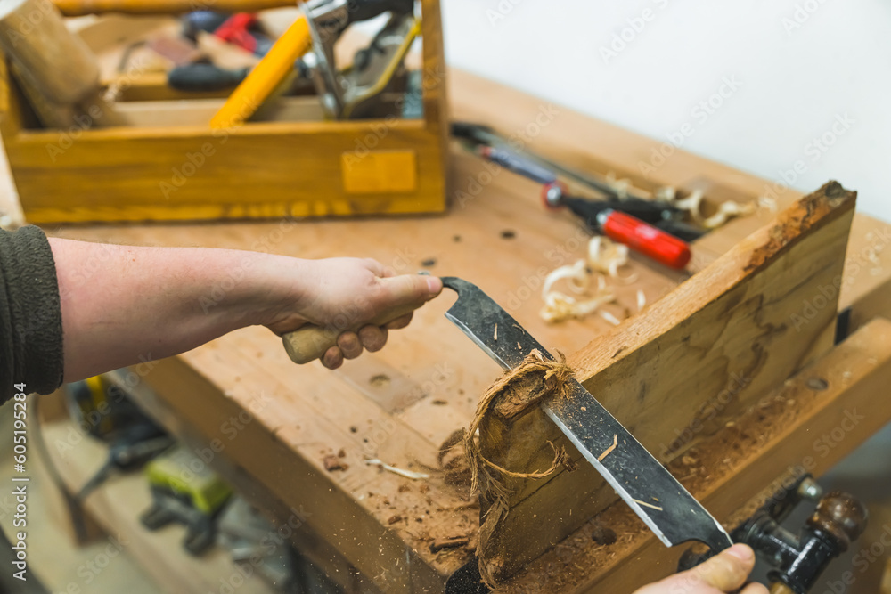Carpenter using draw shave tool to smooth out the wood in a carpenter workshop. High quality photo Carpenter using draw shave tool to smooth out the wood in a carpenter workshop. High quality photo
