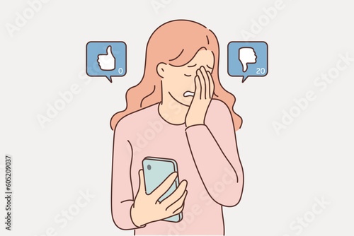 Woman blogger suffers sees dislikes under own post on social network and cries holding phone