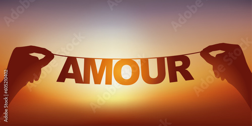 La silhouette du mot amour écrit en lettres détachées sur une guirlande face à un coucher de soleil.