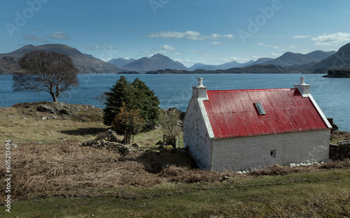 Loch Claira Scottish Highlands. Scotland. Lake.  Little white cottage with red roof. Mountains. photo