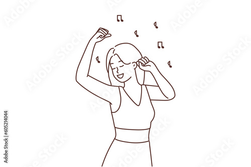 Smiling girl dancing to music 