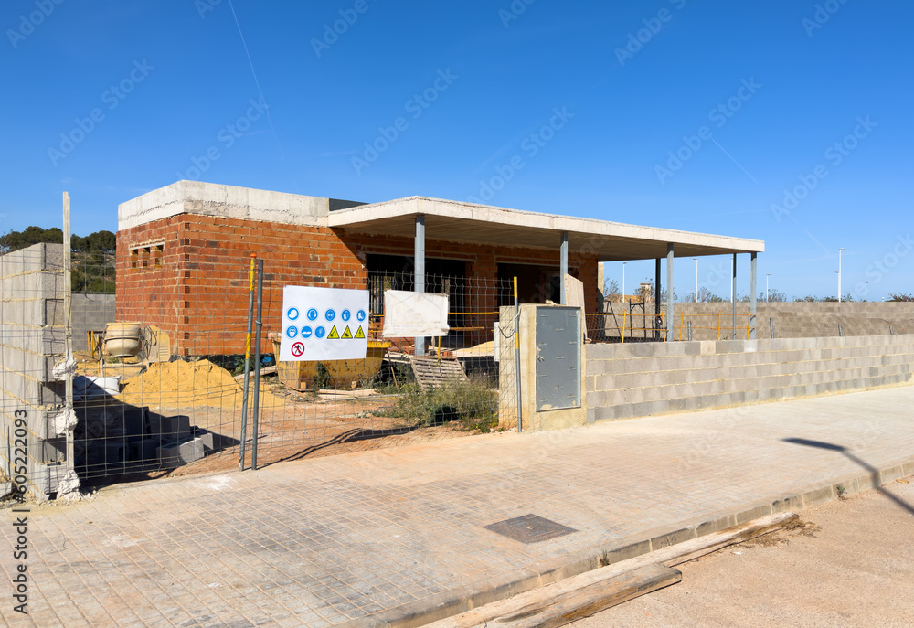 Villa under construction. Townhouse on Construction site. Luxury villa under construction near beach of Mediterranean sea. Construction of modern house near coastline. Home renovation near ocean.