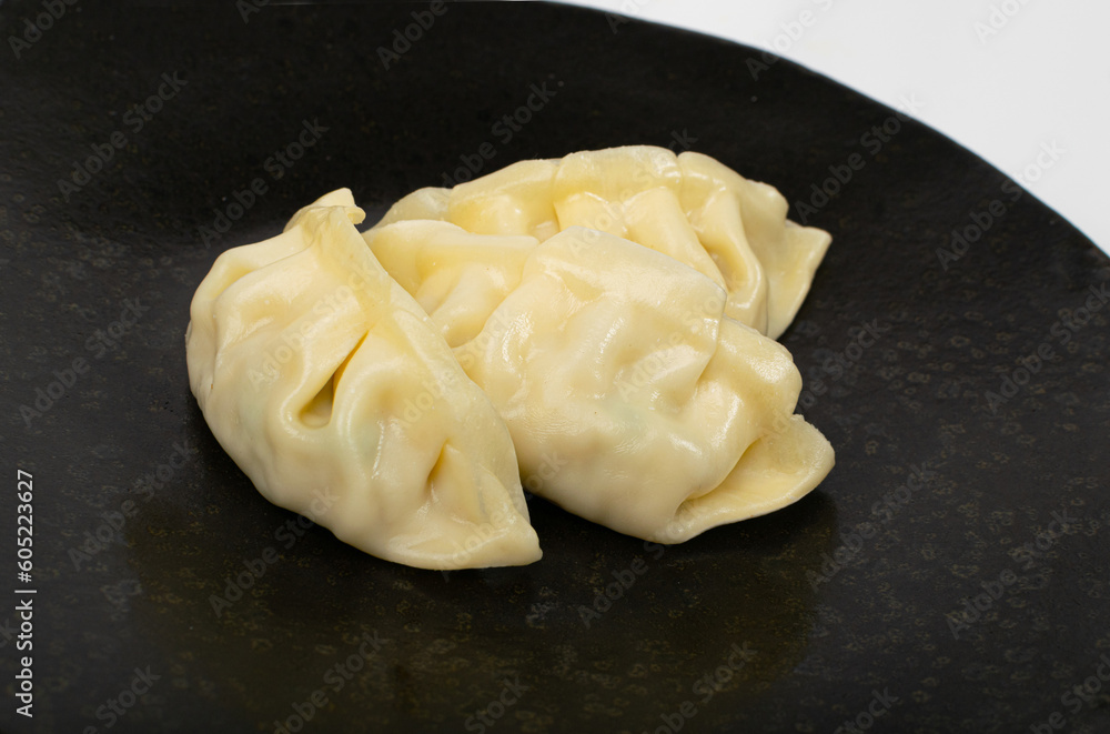 Gyoza Chinese Dumplings on Black Plate Closeup, Vegetable Jiaozi, Macro Chicken Momo Pile, Asian Gyoza Gyoza Chinese Dumplings on Black Plate Closeup, Vegetable Jiaozi, Macro Chicken Momo Pile, Asian Gyoza