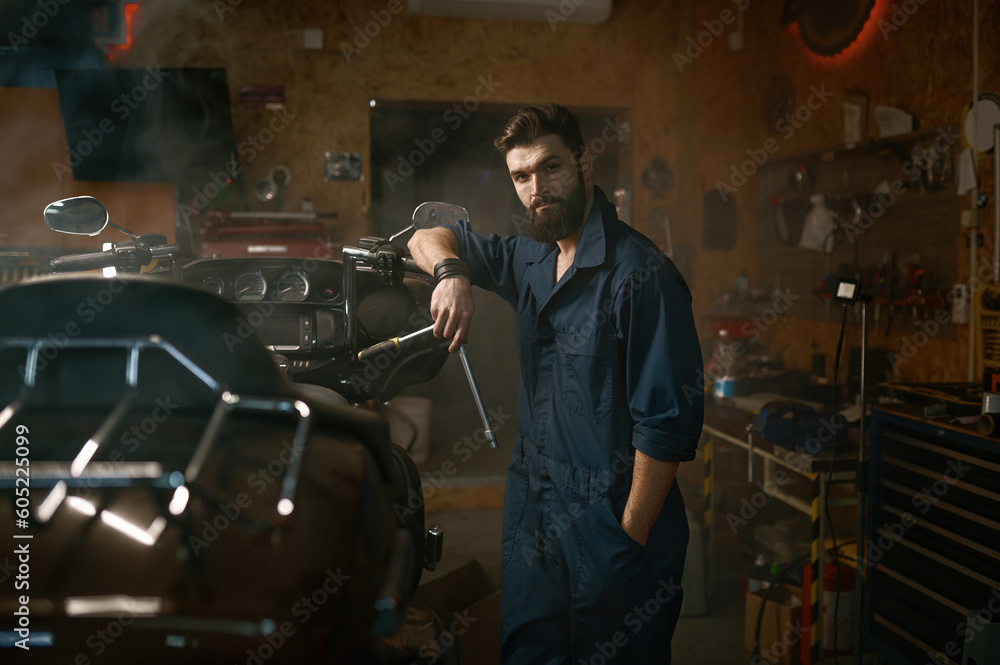 Handsome brutal repairman in work wear looking at camera portrait Handsome brutal repairman in work wear looking at camera portrait