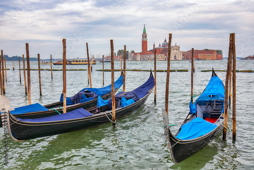 Captivating  landscape with Church of San Giorgio Maggiore on background and gondolas parked beside the Riva degli Schiavoni in Venice © pilat666