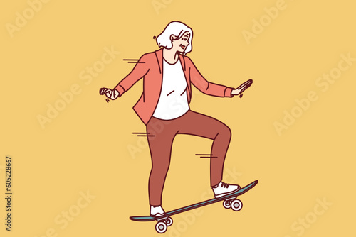 Elderly woman rides skateboard enjoying free time and being active in old age after retirement. Happy grey-haired female rides skateboard has extreme sports hobby in old age and wants to stay young