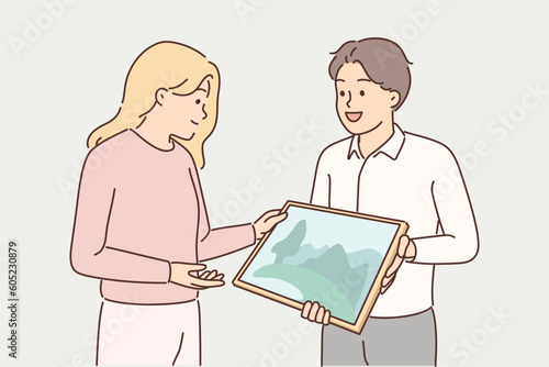 Man artist shows picture to gallery representative wishing to arrange creative exhibition