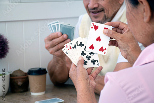Retired people playing card in a retirement home. photo