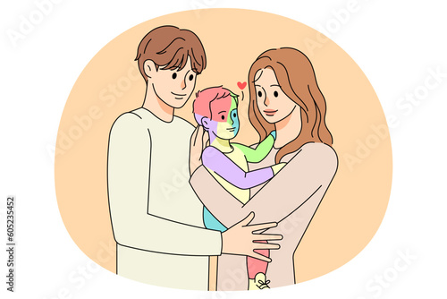 Parents hug small child with autism