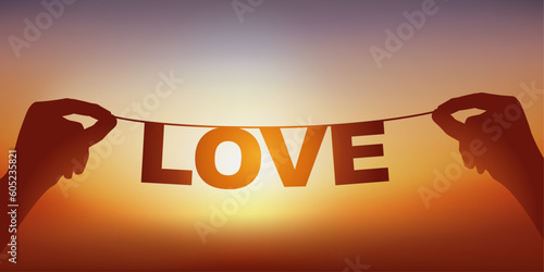La silhouette du mot amour écrit en lettres détachées sur une guirlande face à un coucher de soleil.