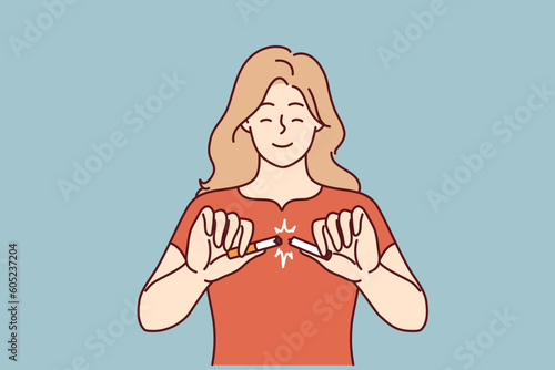 Woman with smile breaks cigarette as sign of fight against nicotine addiction and tobacco smoking. Girl breaks cigarette refusing to use products of tobacco corporations that are harmful to health
