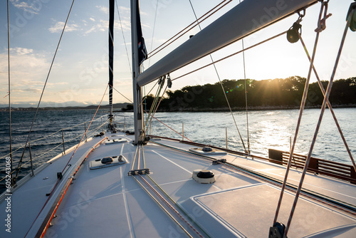 Sailing holiday in croatia at sunset in a bay with turquoise and blue water at summer with a beautiful light and amazing colors.