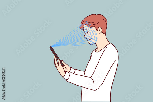 Man uses facial recognition feature on phone to pass verification and gain access to app. Guy with smartphone takes biometric snapshot for verification or authentication instead of entering password