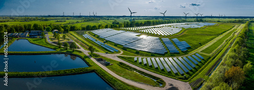 Fotografie, Obraz Environmentally friendly installation of photovoltaic power plant and wind turbine farm situated by landfill