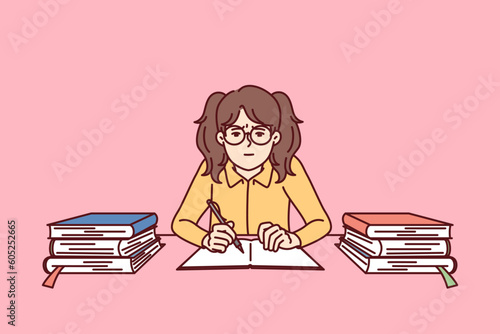 Teenage girl with school books sits in classroom and prepares for difficult exam. Girl from elementary school trains knowledge before olympiad to be smarter than classmates and get good grades