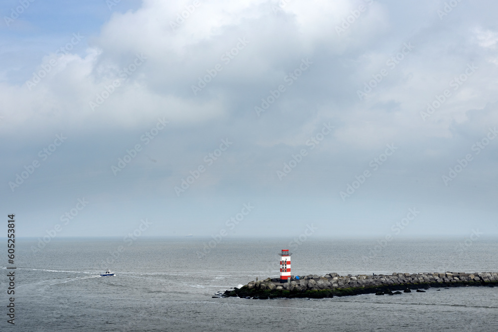 Harbour of IJmuiden Netherlands. Lighthouse and pier. Noordzeekanaal. Ferry.