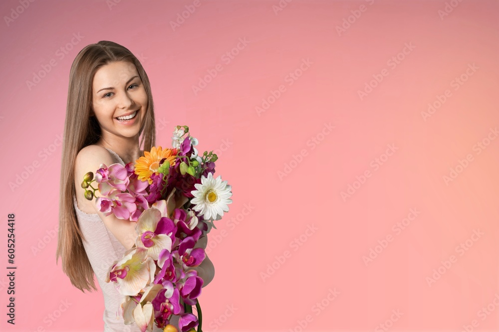 Smiling young lady hold bouquet of fresh flowers