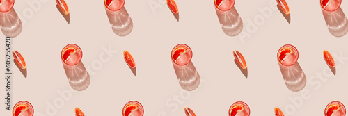 Wallpaper Mural Two glasses of fresh lemonade, water or cocktail, slices of red blood orange with white card note on pastel beige backgound with silk cloth and shadow. Summer refreshment concept. Minimal style.  Torontodigital.ca