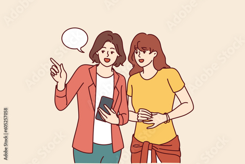 Women with phone walk around city and use navigation application to find right place in city. Traveler girl asks question to passer-by with smartphone to find way in hotel or railway station