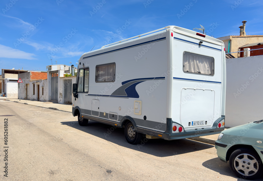 Campervan on parking lot. Classic Motorhome on street. Vintage Camper and old Autocaravanas. Family camper van. Motorhome lifestyle travel. Travel on Campervan along Spain coast. Caravaning Parking.