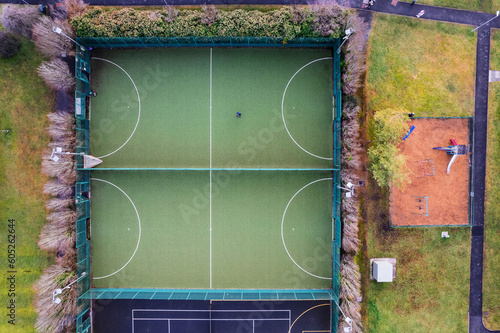 Aerial top down view on a basketball open air ground in a student camp of a college or university. Sport outdoor facility for developing skill and health.