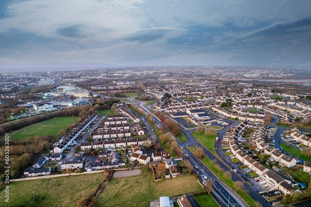 High density residential area in Galway city, Ireland. Sunset sky and warm and cold colors. Aerial view. Town houses in close proximity to each other. Private property.