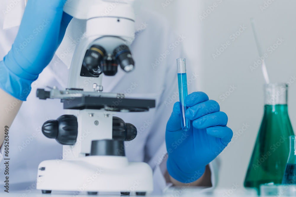 biochemical research scientist team working with microscope for coronavirus vaccine development in pharmaceutical research labolatory, selective focus biochemical research scientist team working with microscope for coronavirus vaccine development in pharmaceutical research labolatory, selective focus