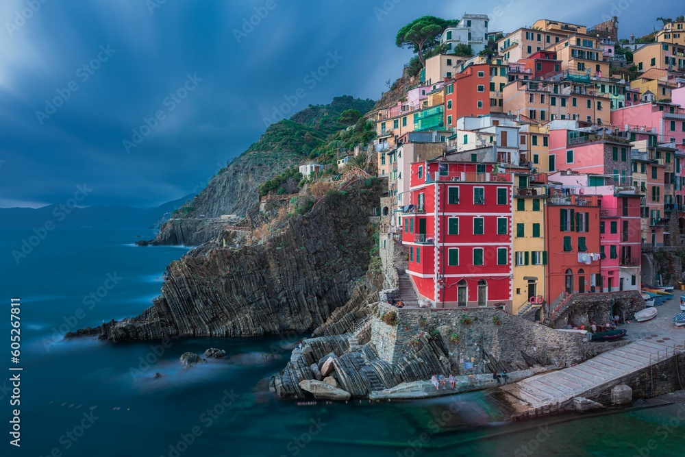 Beautiful shot of a historic colorful village on a cliff near the shore of Riomaggiore, Cinque Terre