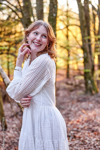 smiling redhead girl in a forest