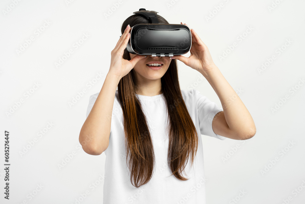 Excited Teenager girl using virtual reality glasses isolated on white background. Technology, innovation concept Excited Teenager girl using virtual reality glasses isolated on white background. Technology, innovation concept