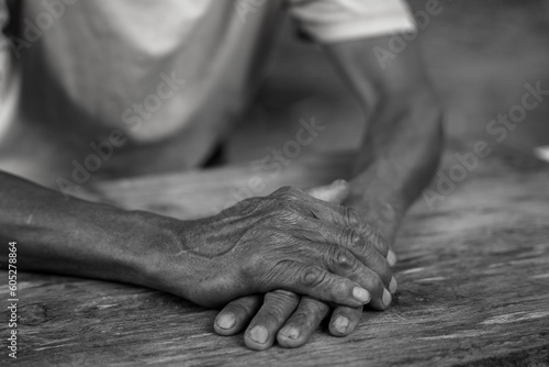 Close up of elderly oldman hands on wooden table.