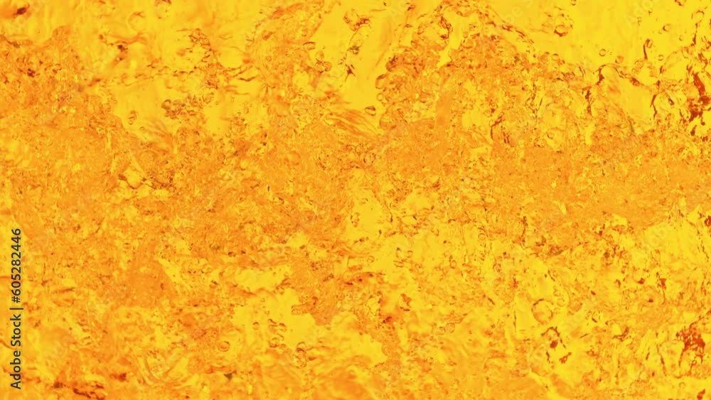 Super slow motion of splashing whiskey, close-up. Filmed on high speed cinema camera, 1000 fps. Top view shot composition. Speed ramp effect. Super slow motion of splashing whiskey, close-up. Filmed on high speed cinema camera, 1000 fps. Top view shot composition. Speed ramp effect.