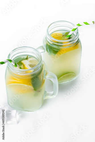 Lemonade drink in a jar glass and ingredients isolated on white background.
