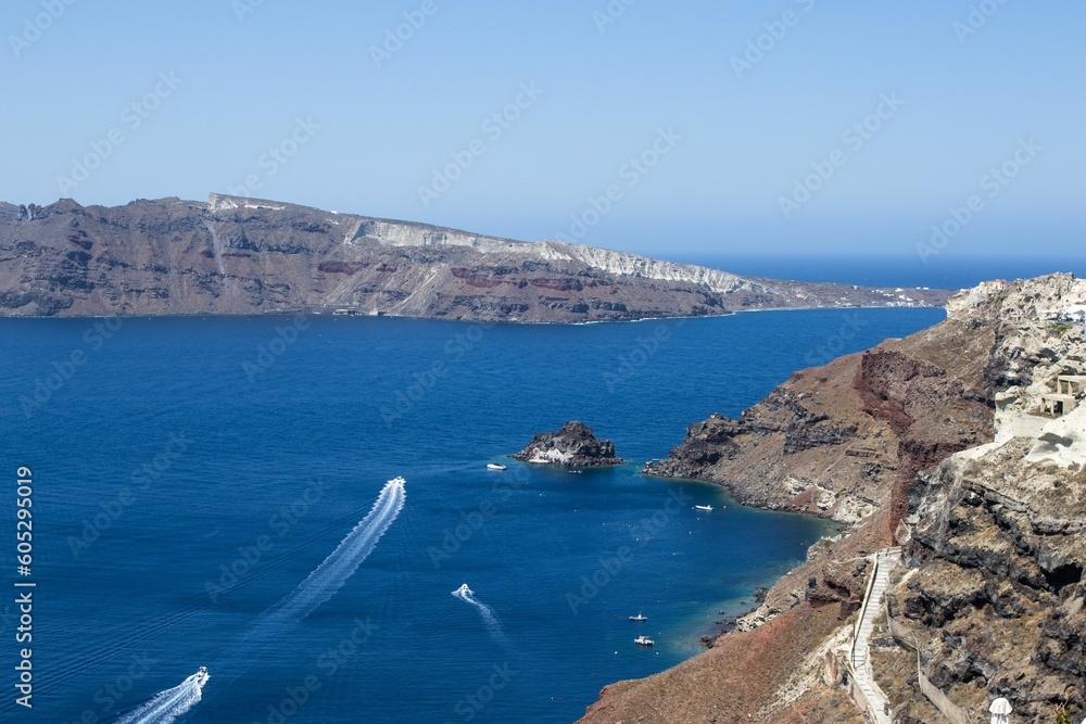 Aerial view of the waterside cliffs at Oia village on a sunny day