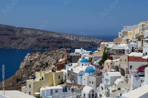 Aerial view of Oia village coastal buildings on a sunny day in Greece