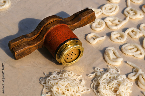 Making of Wheat Kurdai or kurawadi (String Papad), Kurdai are produced at home in India using only regional and traditional techniques. usually made during the summer in Maharashtra, India. photo