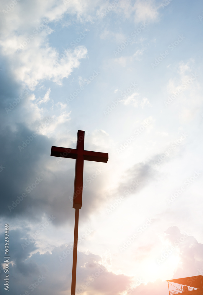 A christian cross under cloudy sky