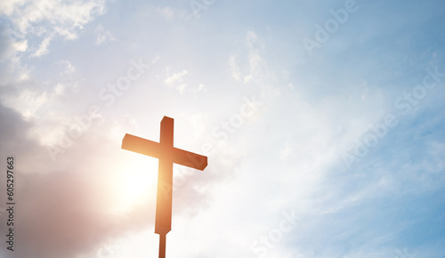 Photography A christian cross under cloudy sky