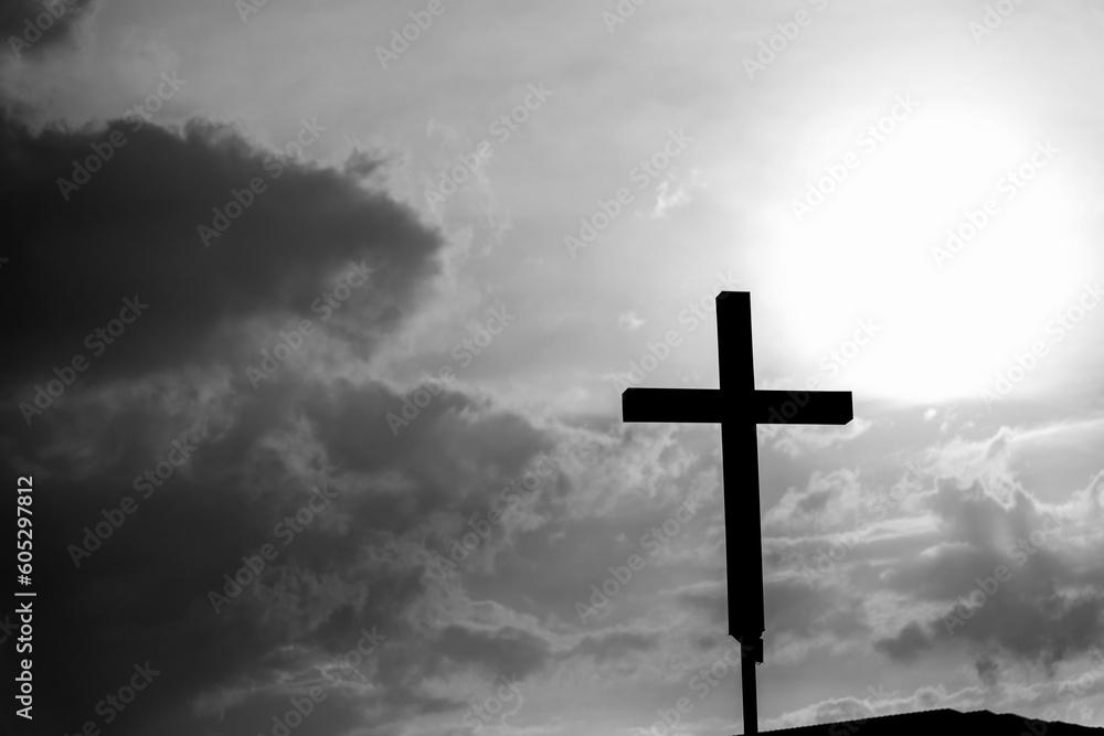 A christian cross under the dark sky