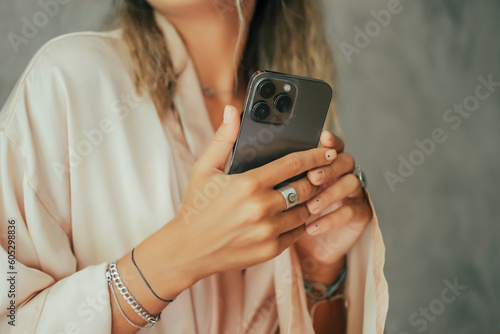 Young beauty girl brunette hair make selfie on smartphone, happy face, outdoor hipster portrait on the street,smile happy face,listen music on headphones, Amsterdam street, dance, player,photo concept