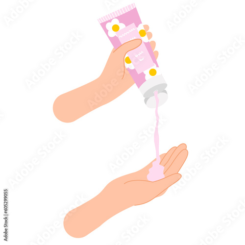 Hand holding hand cream with floral design .Hand squeezes cream on hand. Skin care routine.