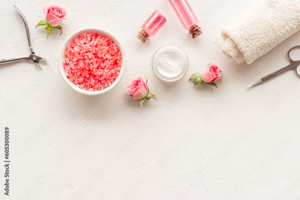 Hands and nail care cosmetic set with pink roses flowers.