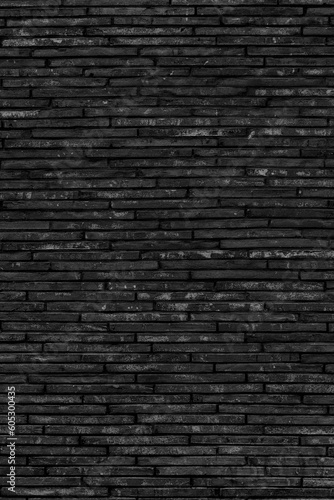 Vertical shot of a black brick wall texture background