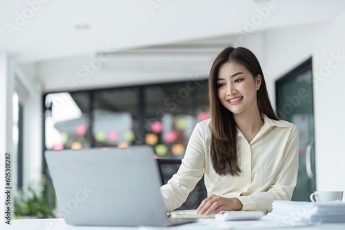 business young woman happy cheerful cute beautiful business woman sit in office using laptop computer