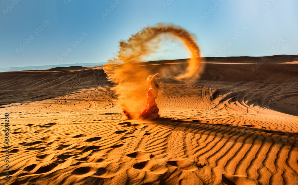 Woman in red walking on a dunes
